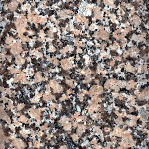 Pinkish stone with dark speckles