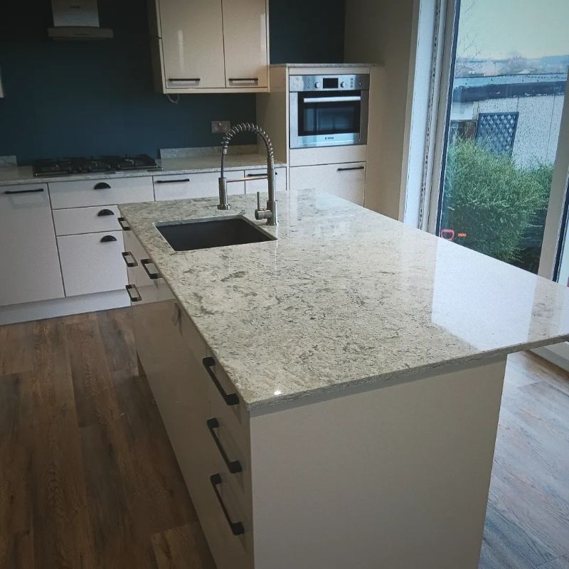a kitchen and a sink and a stone work top