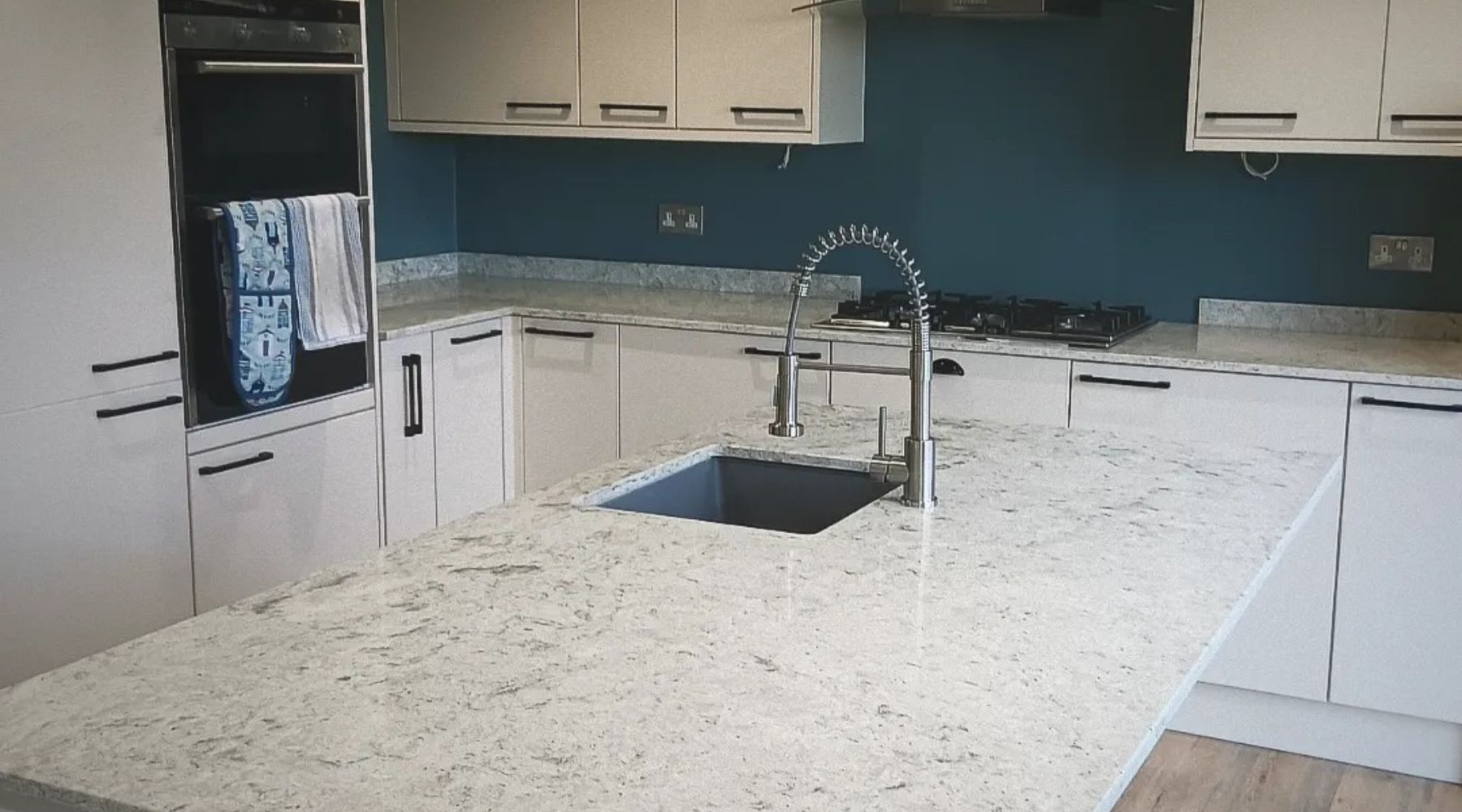 a kitchen with a sink and stone worktop